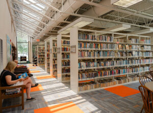 Interior of a library with people seated reading.