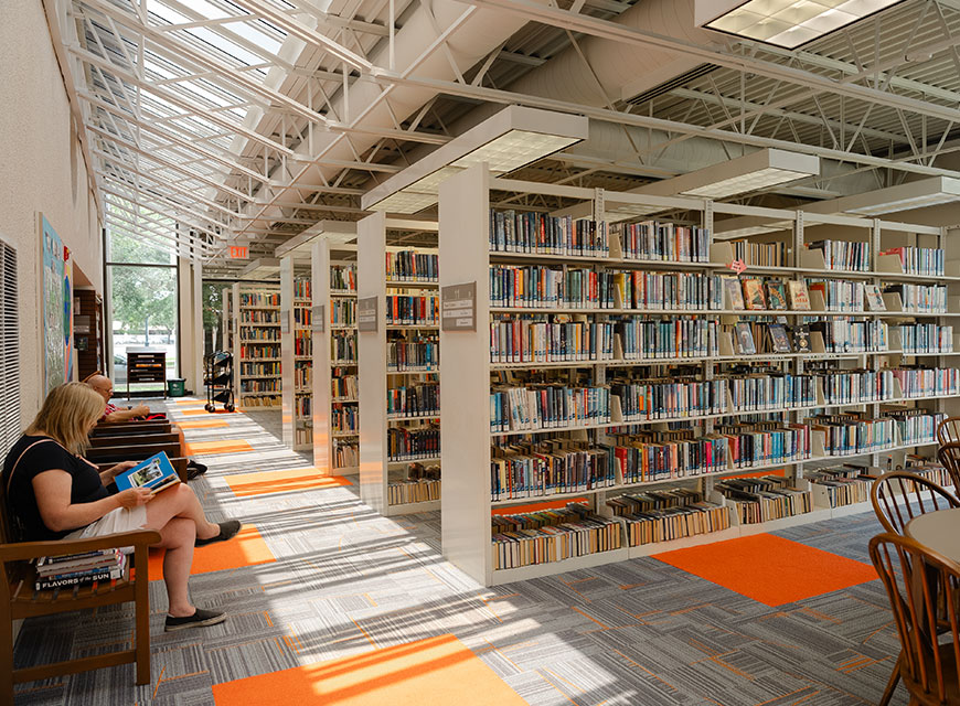 Interior of a library with people seated reading.