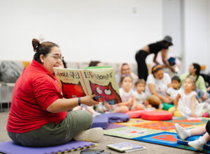 Woman reading to a group of children.