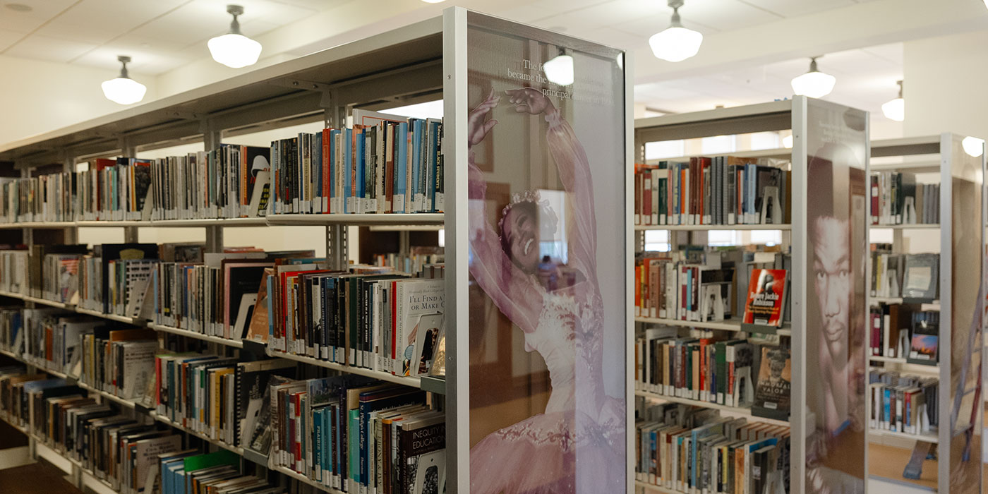 Bookshelves with portraits of famous African Americans on display.