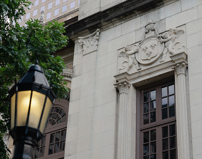Exterior of a library building with decorative windows and lamppost.