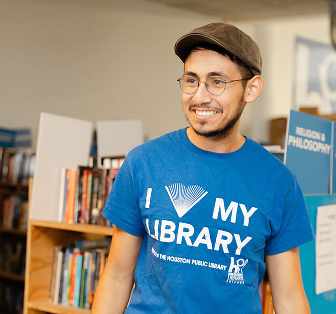 Young volunteer in the library wearing an "I love my library" t-shirt.