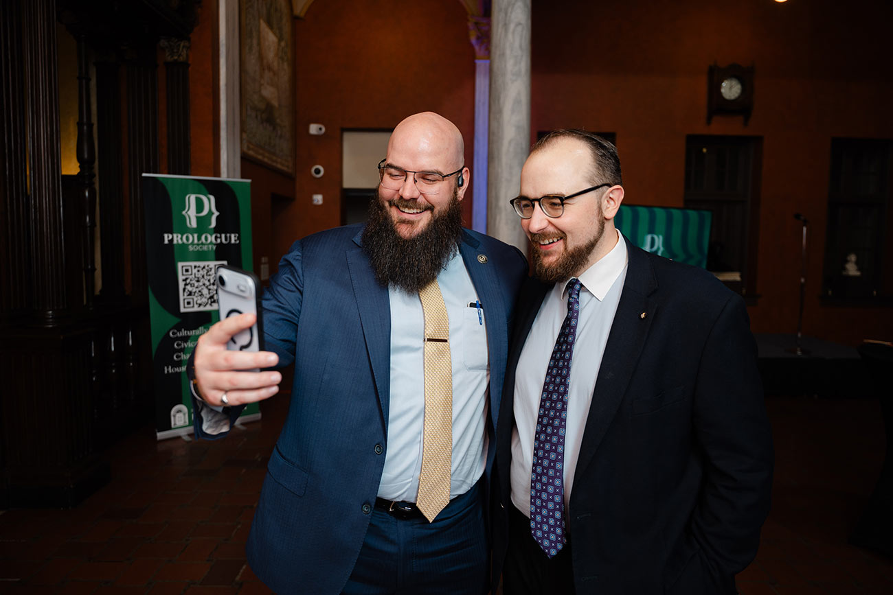 Two friends take a selfie at a Prologue Society event.